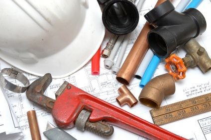 Plumbing parts, tools, and plans used by Mr. Plumber.